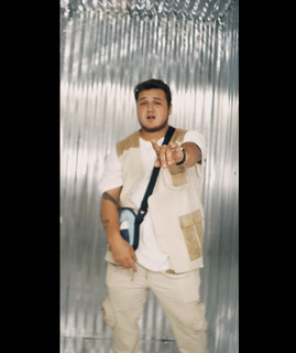 Av3rage standing in a white sleeveless outfit
