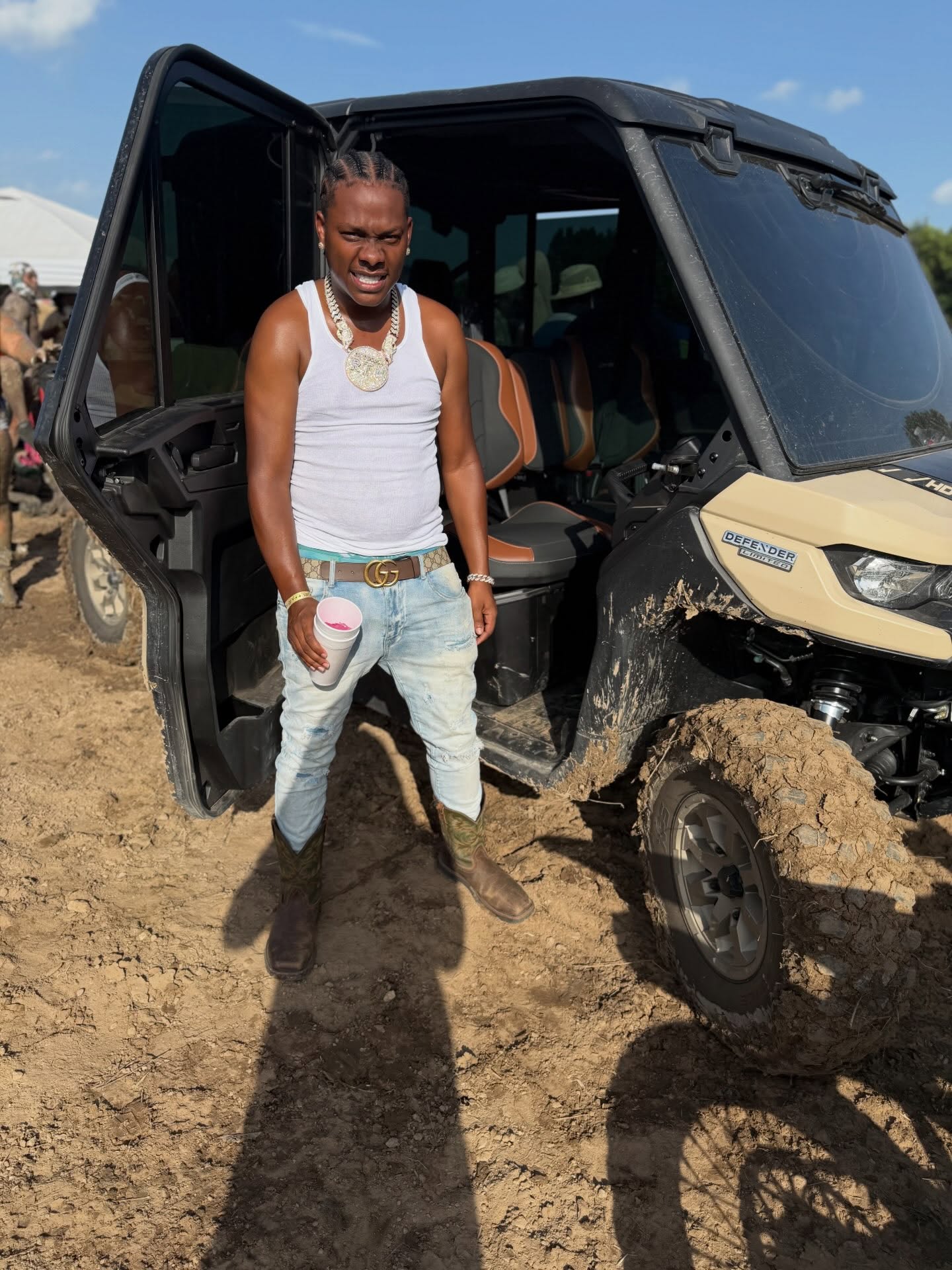 Cootie standing beside an off-road vehicle