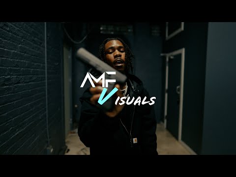 Darri Glo rapping in a dark hallway in a music video