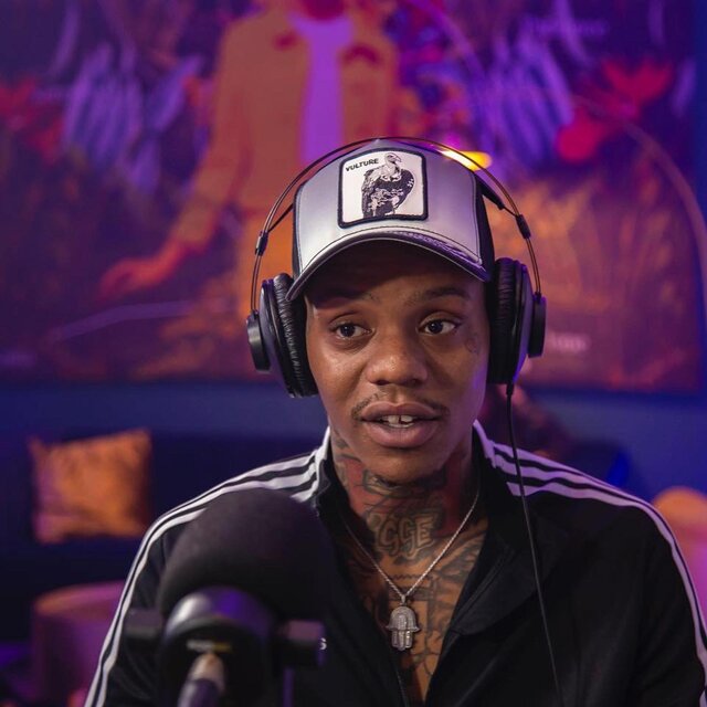 El Hitta seated in a studio portrait