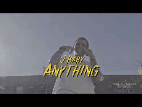 J Baby standing outdoors in the Anything music video