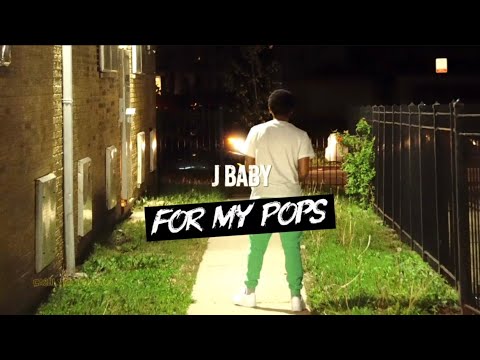 J Baby standing in a backyard at night in the For My Pops video
