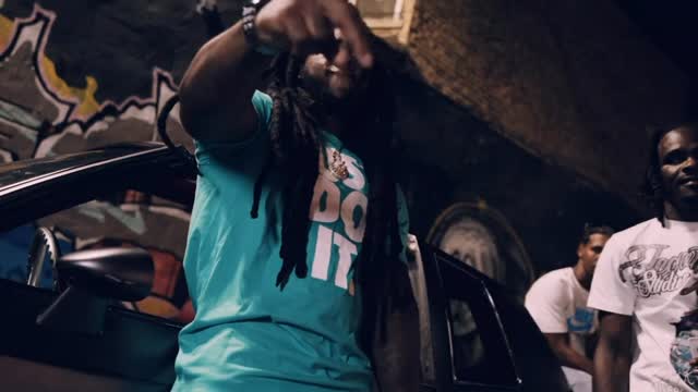 Mula XO performing beside a car in an Avenue Baby2 music video