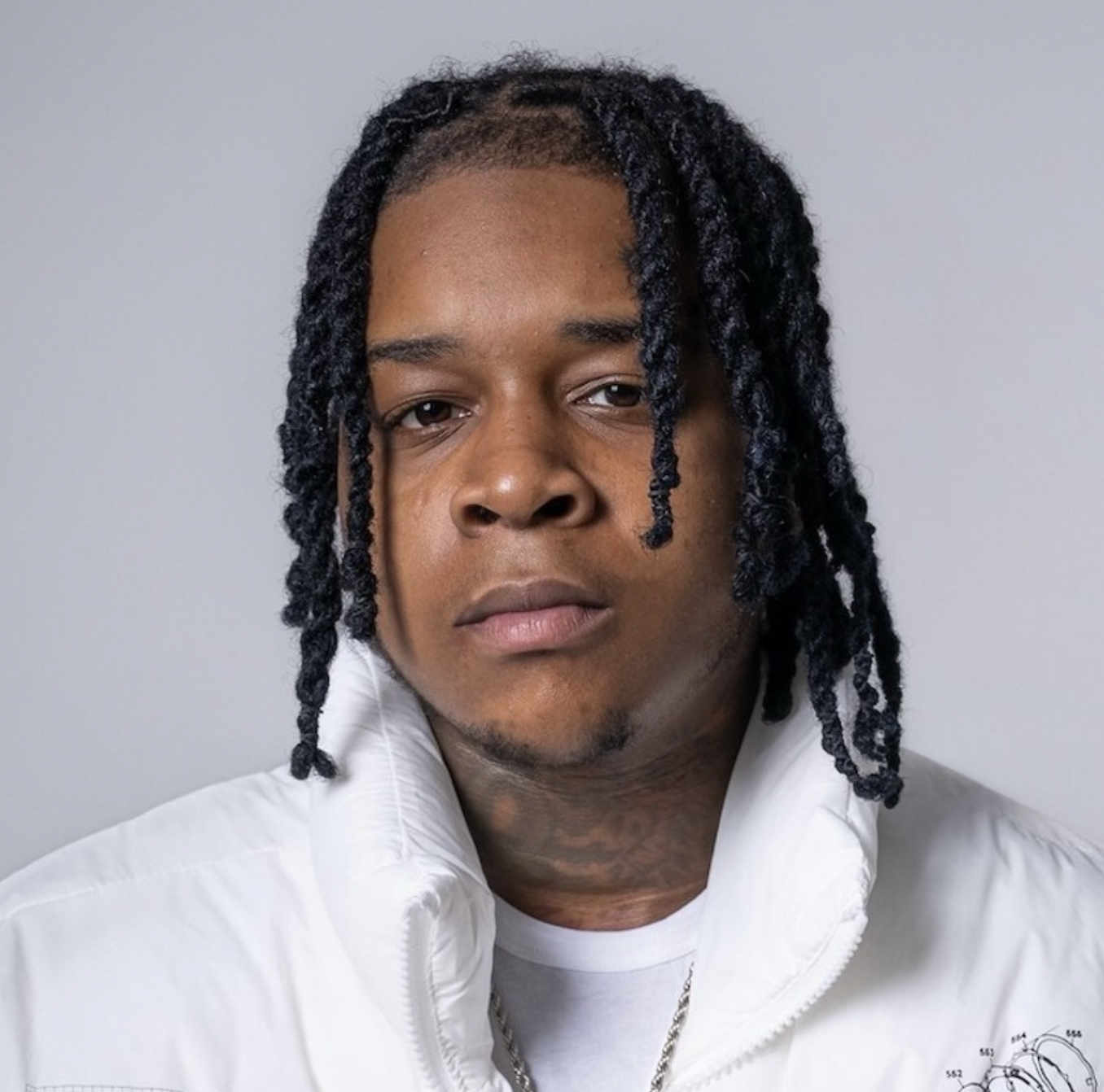 YTB Fatt wearing a white puffer jacket and silver chain