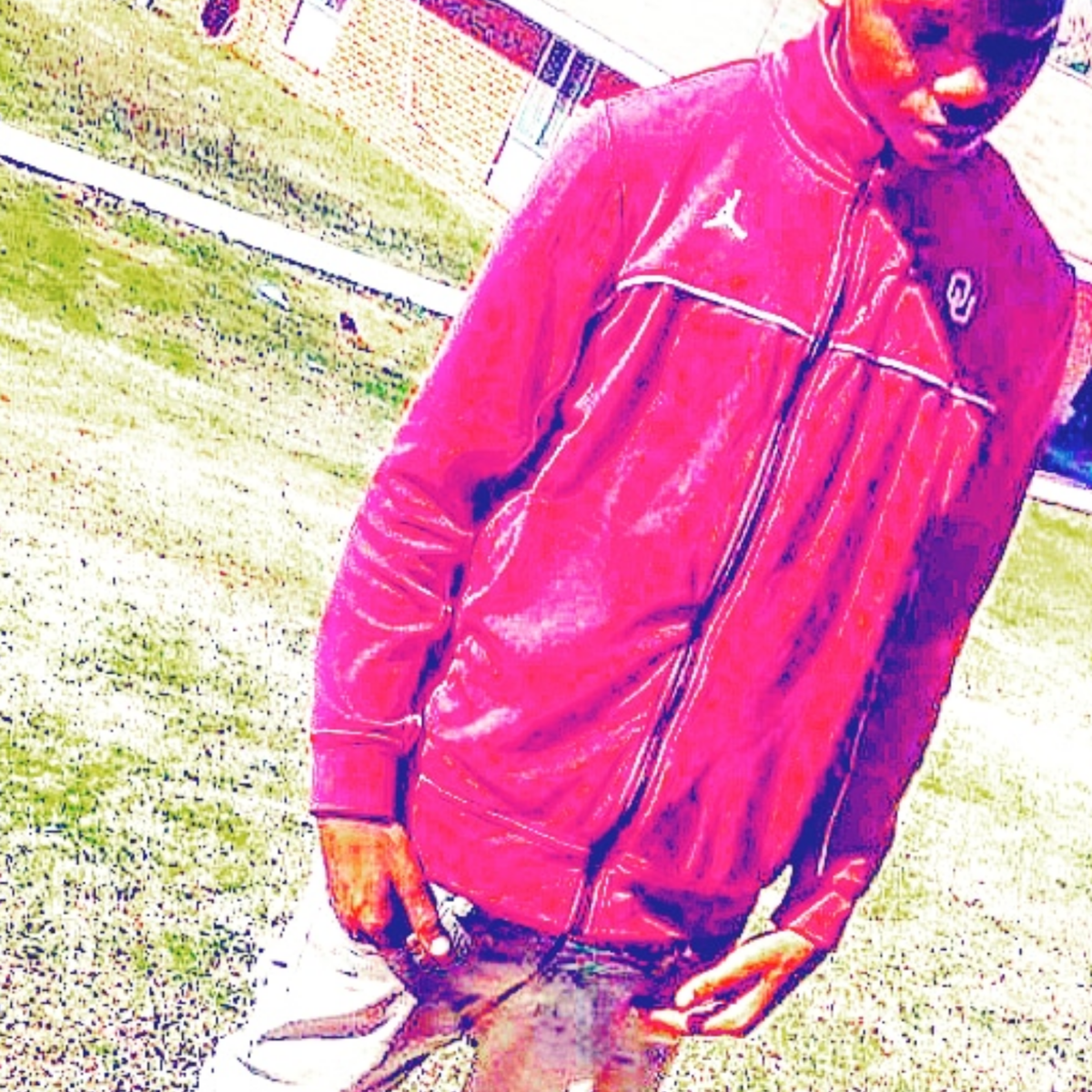 YUNGEEN K3 standing outdoors in a red Jordan tracksuit