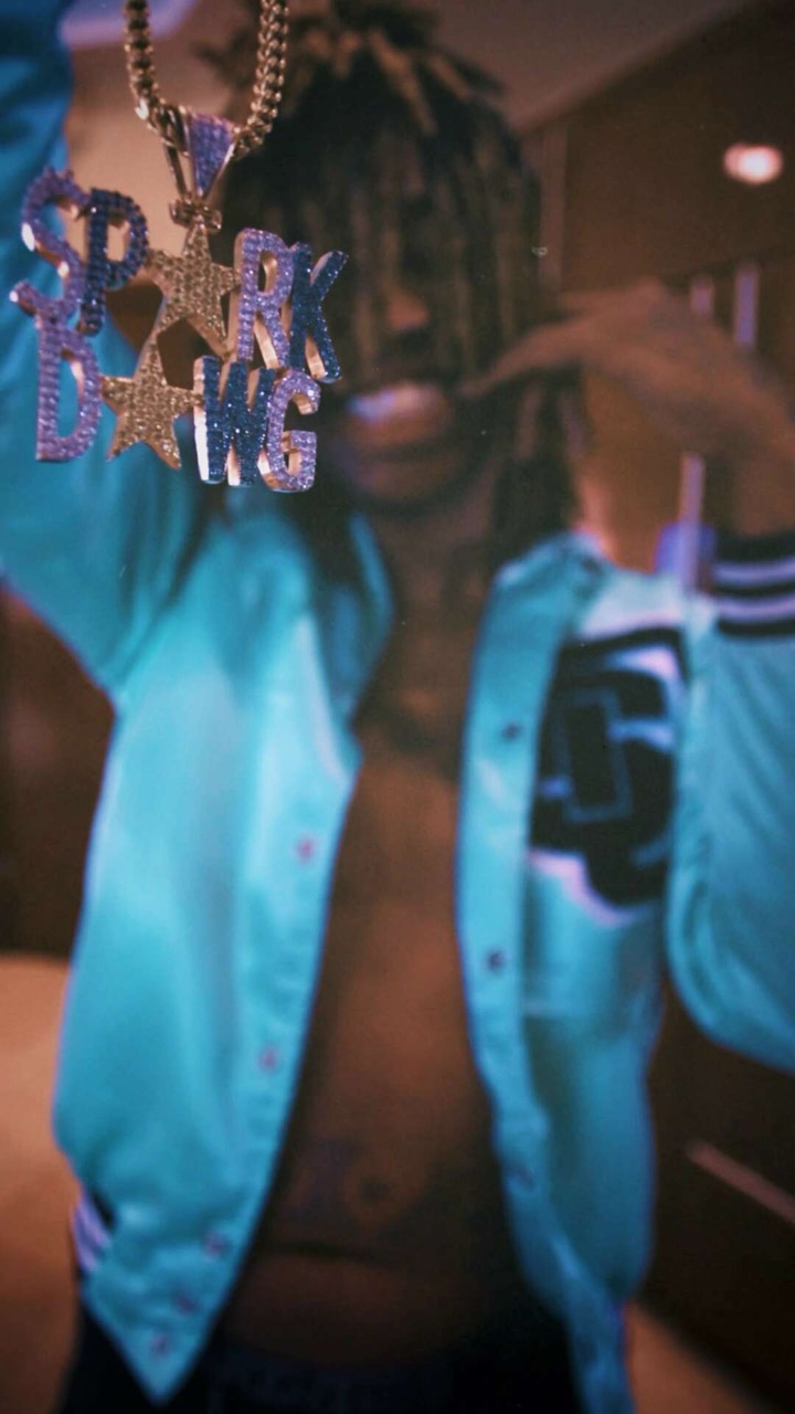 Spark Dawg wearing his Hood Dentist pendant